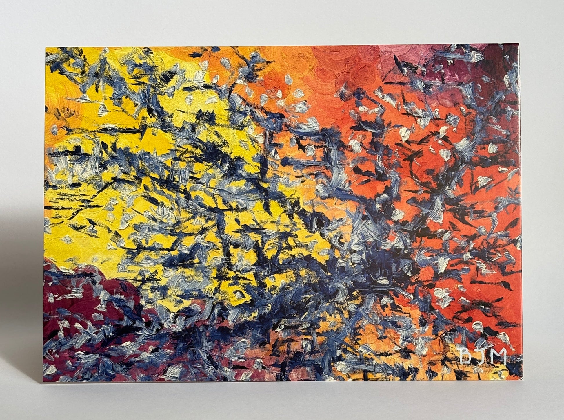 Abstract painting with vibrant colors on a white wall.