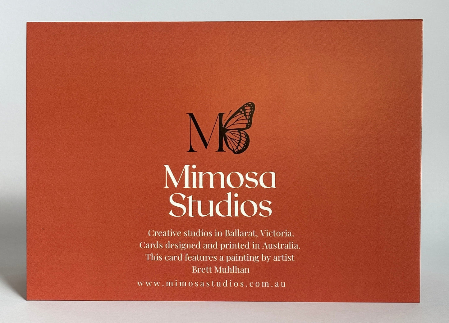 Orange card with 'Mimosa Studios' logo and text on a light gray background