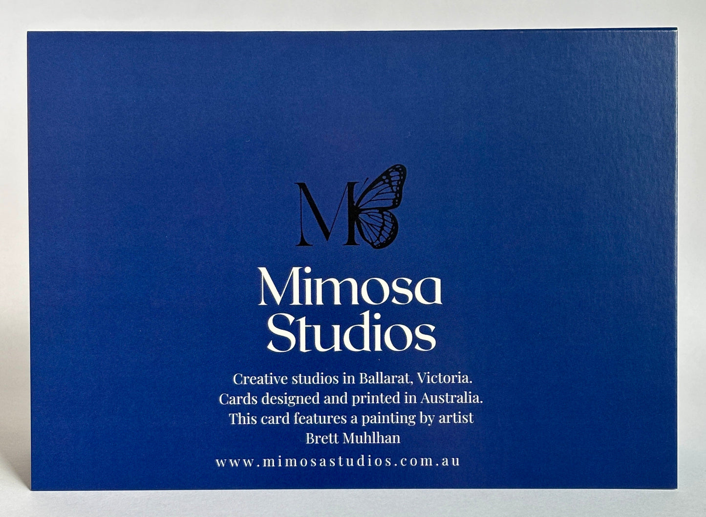 Blue card with Mimosa Studios branding and text on a white background