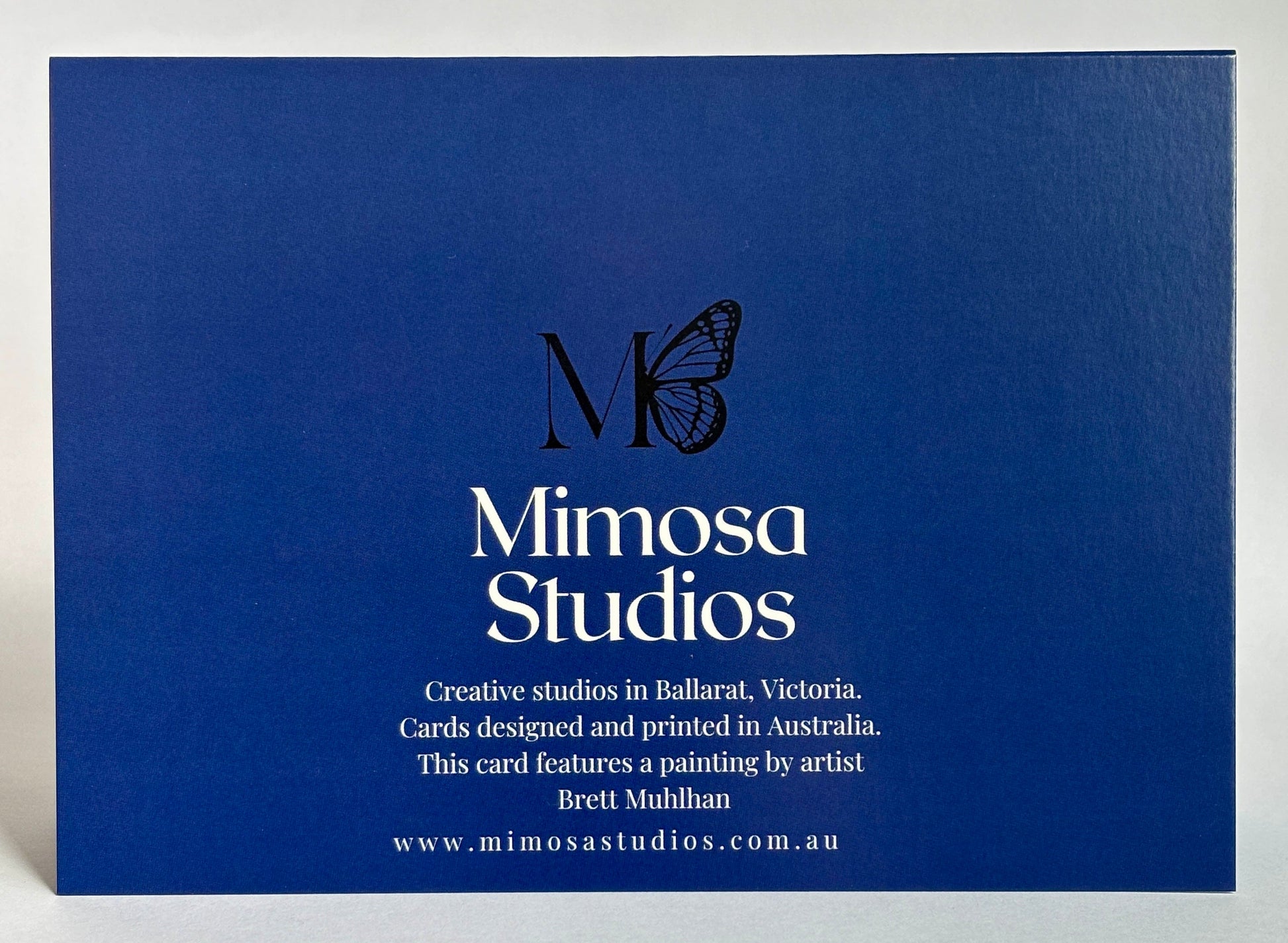 Blue card with Mimosa Studios branding and text on a white background