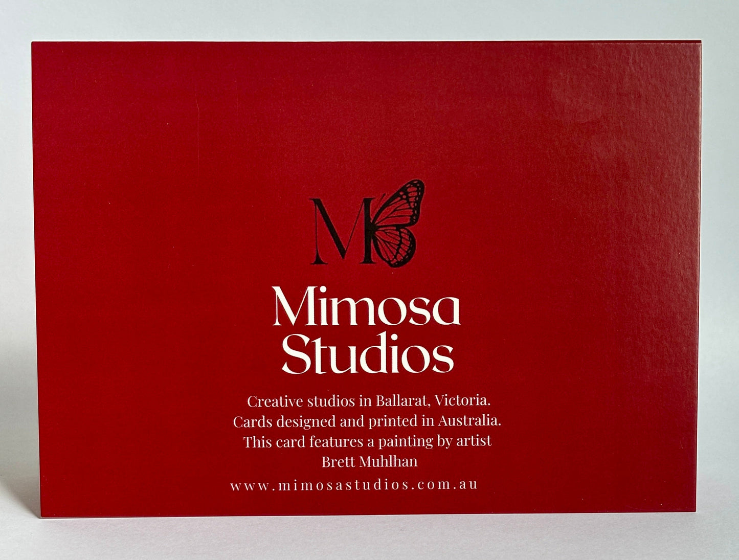 Red card with 'Mimosa Studios' branding and butterfly logo on a white background