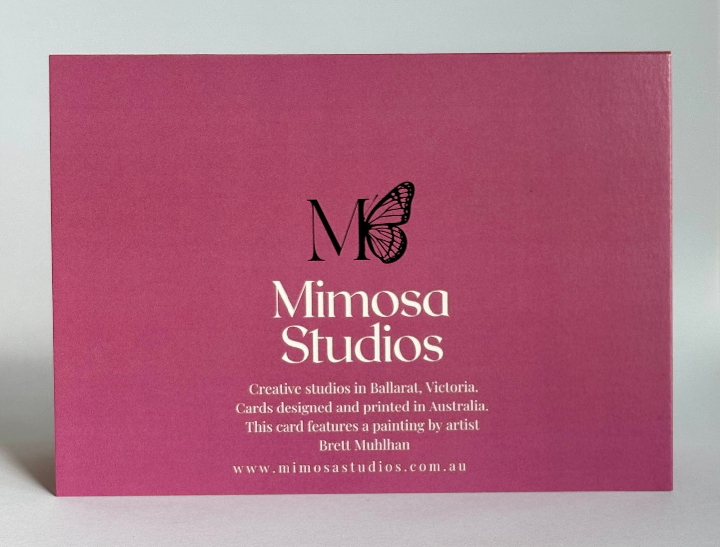 Mimosa Studios card with butterfly logo on a pink background