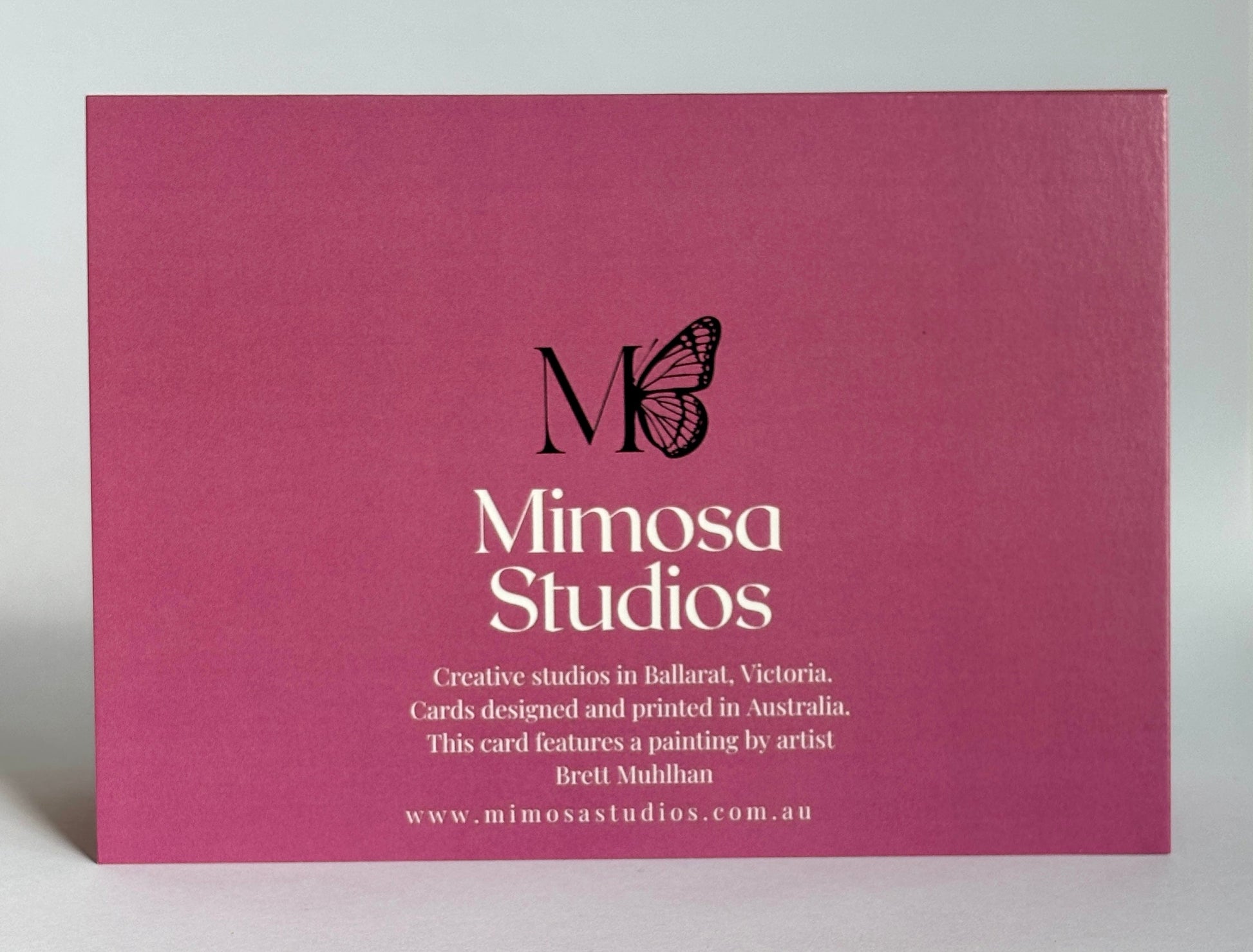 Mimosa Studios card with butterfly logo on a pink background