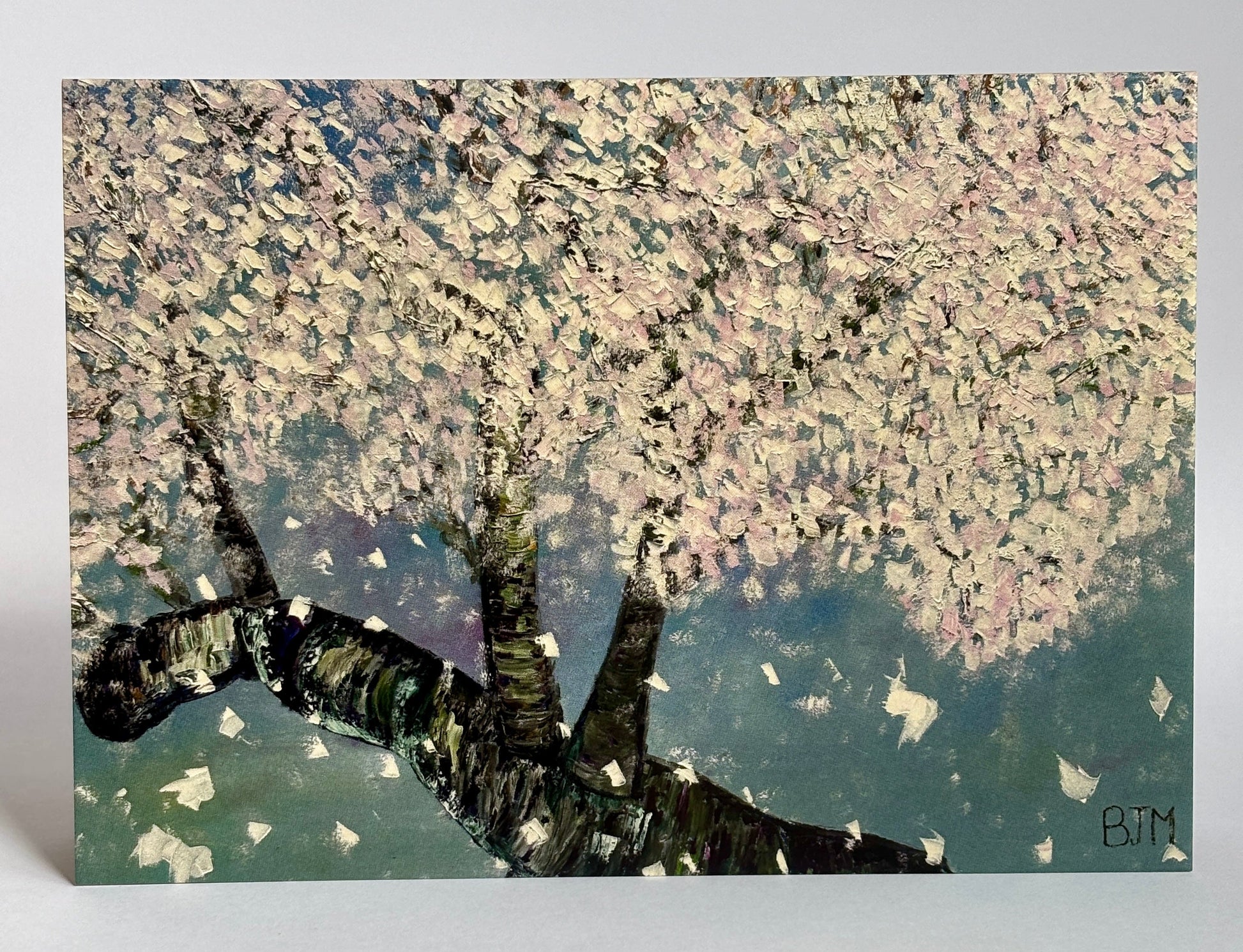 Artistic depiction of a cherry blossom tree with pink blossoms on a textured background