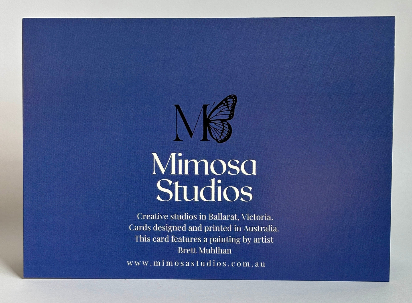 Blue card with Mimosa Studios branding and a butterfly logo on a gray background