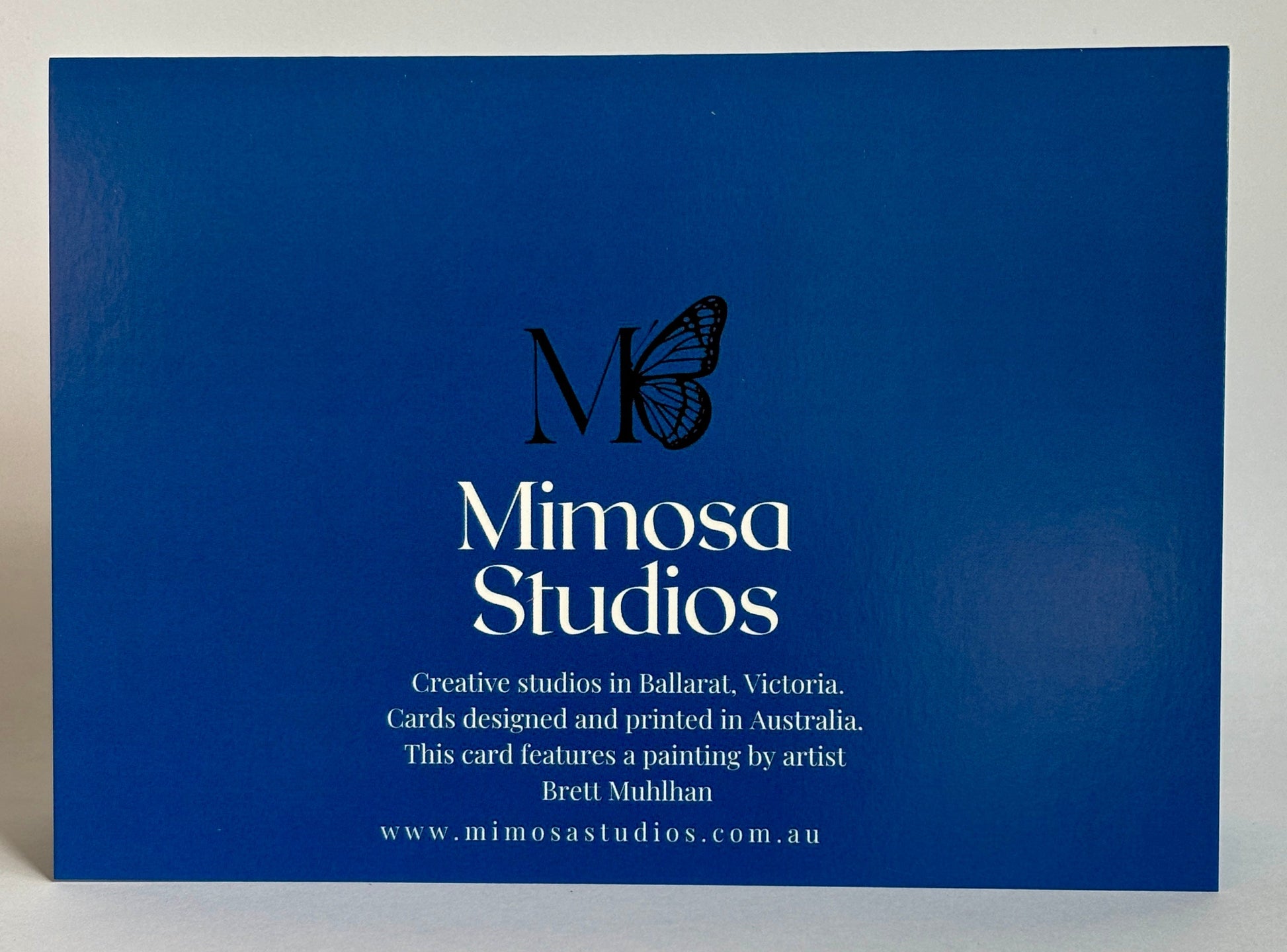 Blue card with Mimosa Studios branding and text on a gray background