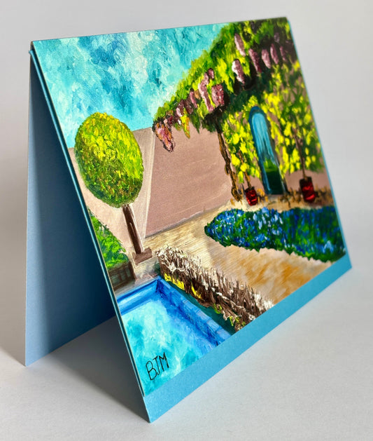 Artistic depiction of a garden scene on a stand with a blue border.