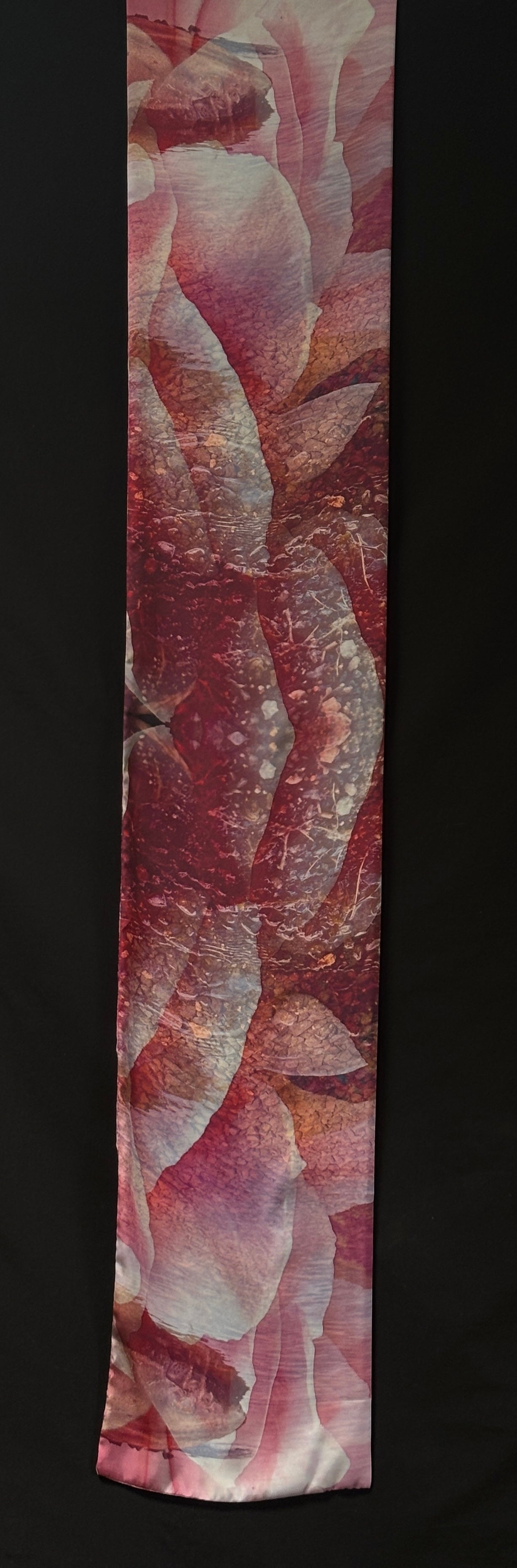 Front of scarf approximately 185cm x 33 cm. Pink petal shapes over pebbles and ripples.