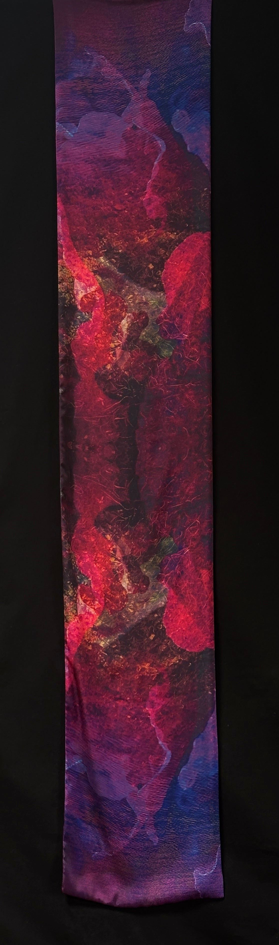 Front of scarf approximately 185cm x 33 cm. Abstract colours - pinks, purples, reds, brown and little bits of yellow. Can see ripples of water, and seaweed patterns.
