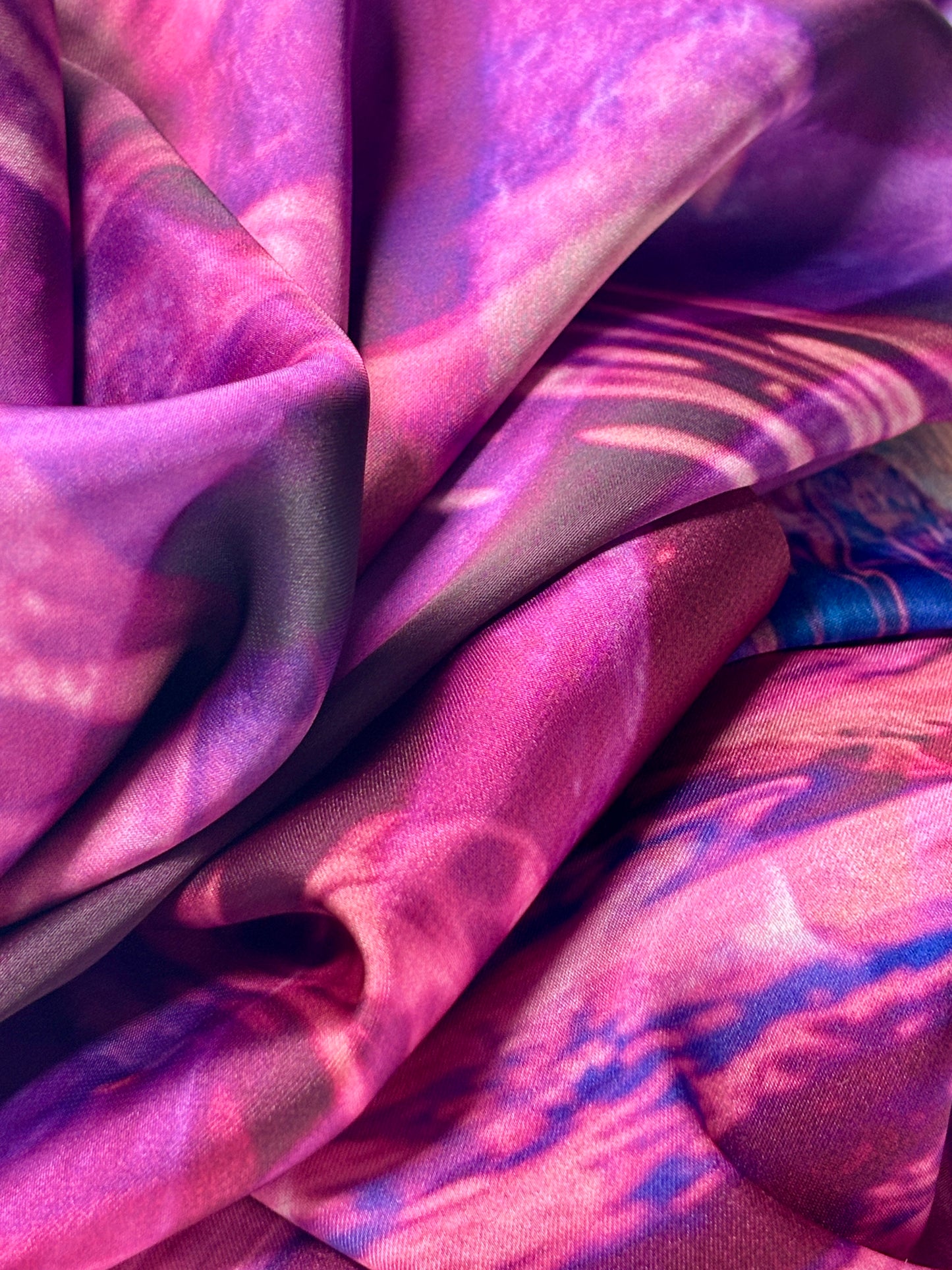 Close up of fabric of Rosa Munstead scarf with patterns in pink, purple and blue.