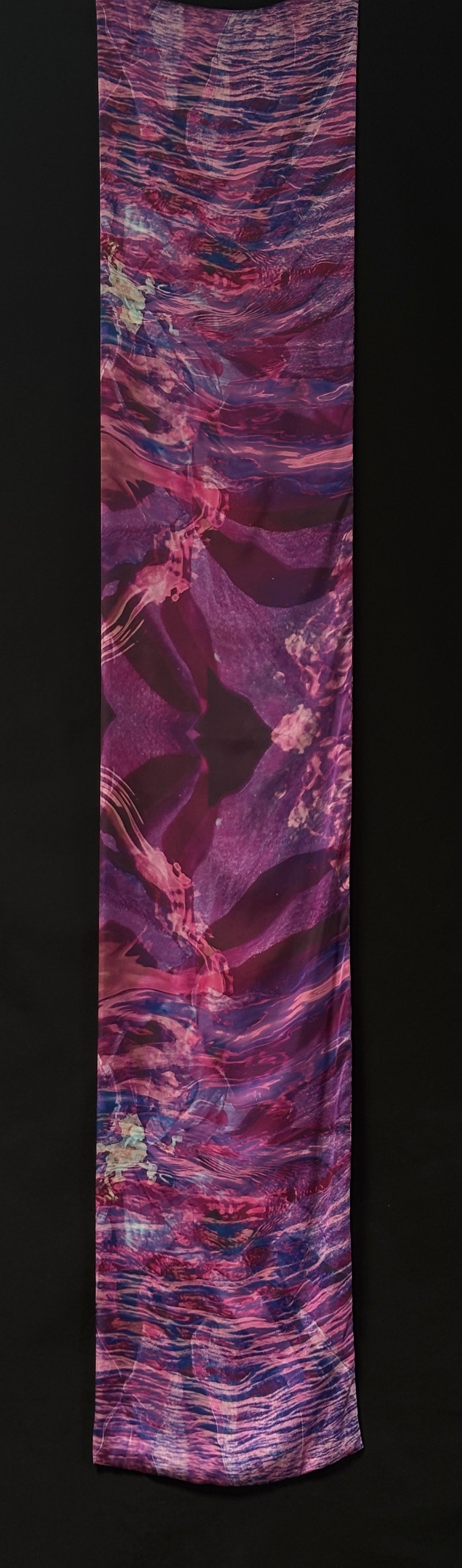 Front of scarf approximately 185cm x 33 cm. Abstract colours - pinks, purples, and blue. Can see ripples of water, and flower patterns.